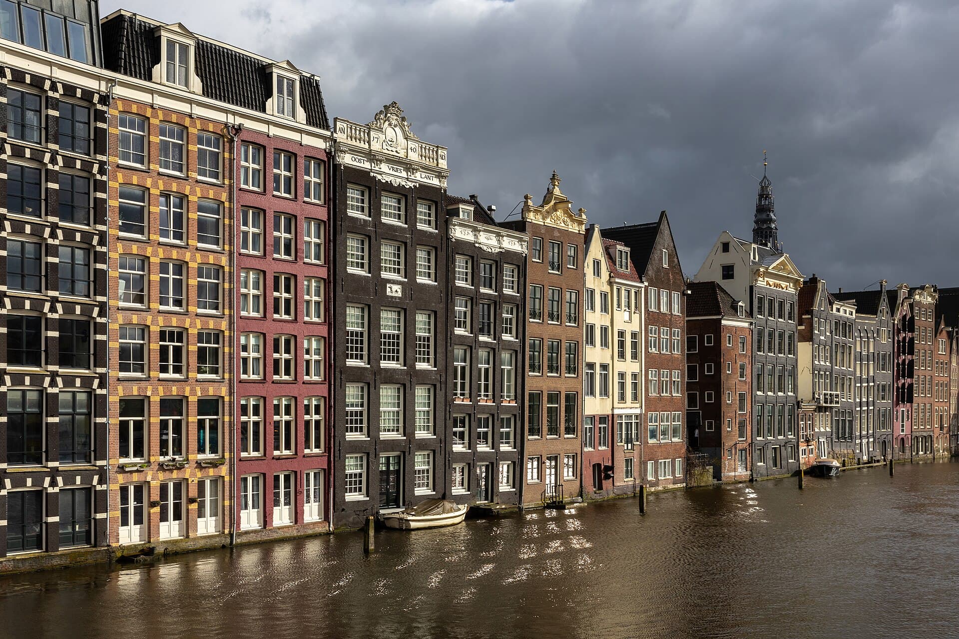 Colorful canal houses at golden hour in Damrak avenue Amsterdam the Netherlands.jpg